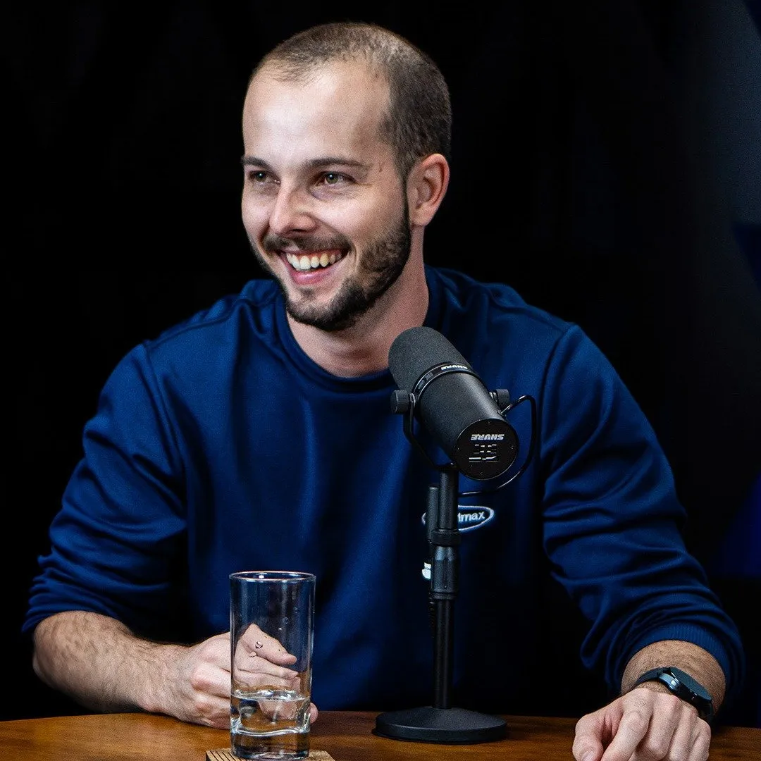Herbert Lausmann sorrindo durante a gravação de um podcast